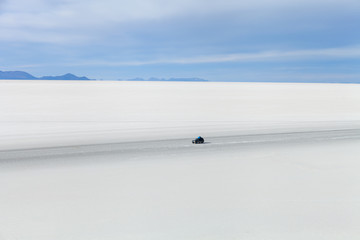off-road vehicle driving on Salar de Uyuni