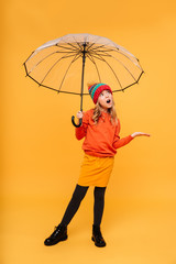 Full length image of Young girl in hat with umbrella