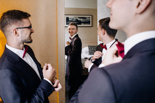 Three handsome male friends meet and speeking each other. Groomsman or best man greeting groom at wedding day.