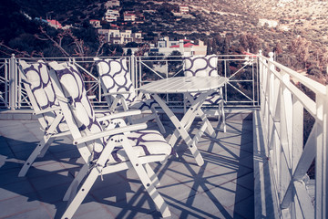 chairs with a table on the terrace by the sea, Greece
