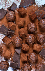 Chocolate shonfet with praline, truffles, chocolate, cocoa. Chocolate photo background.
