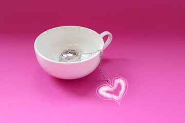White tea cup with teapot on color background. Concept design.
