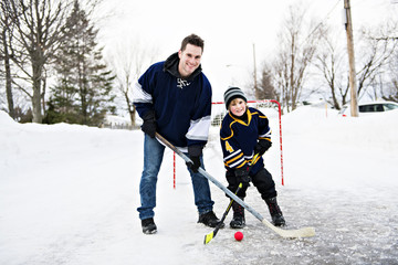 Father and son playing hockey