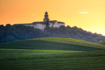 Pannonhalma Archabbey with wheat field on sunset time