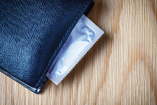 Condom put inside man wallet, Safe sex concept