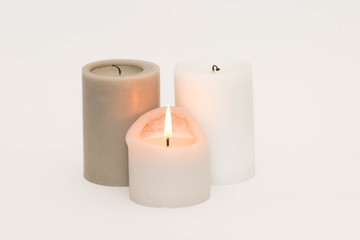 Fototapeta na wymiar Set of three candles against a white background