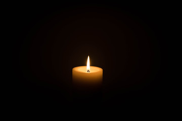 Single burning candle against a dark background