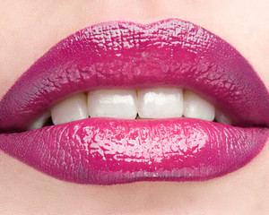 Obraz premium The female lips which are made up by red lipstick.