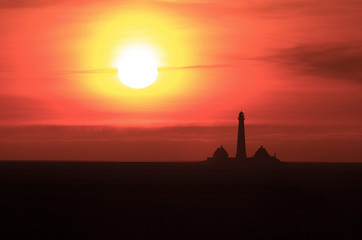 Lighthouse at sunset.Westerhever lighthouse at sunset,North sea coast,Germany.