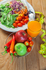 Healthy concept with mixed fruits and vegetables on wooden background