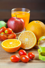 Healthy concept with mixed fruits and vegetables on wooden background