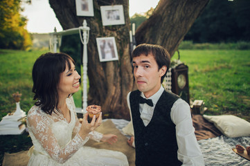 distant view of young caucasian engaged couple on romantic picni