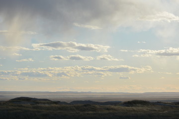 Clouds dropping toward surface of the Badlands.