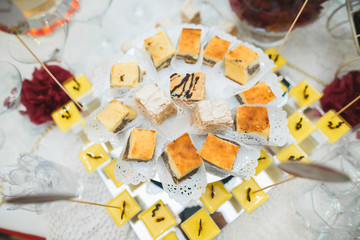 Delicious sweets on wedding candy buffet with desserts, cupcakes