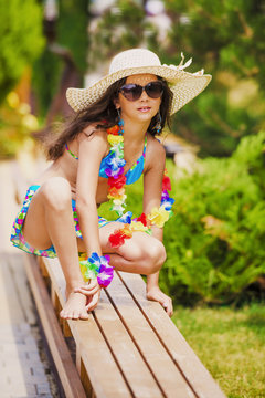 Beach charming young girl. Wide-brimmed hat, Hawaii funny style.