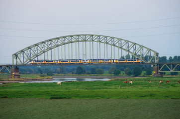 Train on rail bridge in Arnhem, the Netherlands