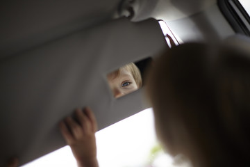 Boy looking into mirror on visor