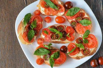 Sandwich with bread and butter, tomatoes and basil