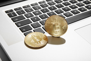 Cryptocurrency coins Bitcoin on computer laptop keyboard
