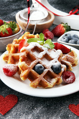 Valentine concept. Traditional belgian waffles with fresh fruit and powder sugar on wooden board