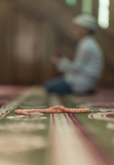 boy Muslim is praying in mosque