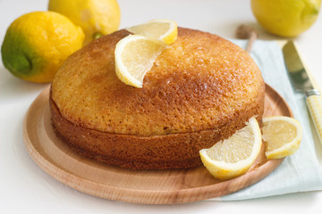 Lemon lavender cake and lemons on a light background. Rustic style.