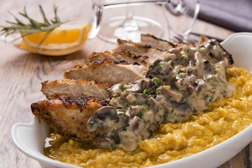 rice paella with curry fried chicken breast and mushrooms in creamy sauce