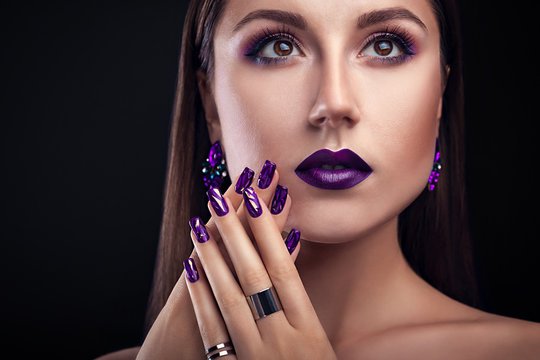 Beautiful woman with perfect make-up and manicure wearing jewellery