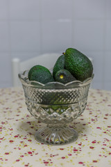 Ripe avocados in a glass bowl