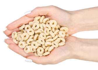 Breakfast cereal rings in a hand