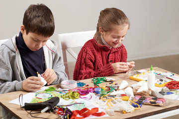 Children make crafts and toys, handmade concept. Artwork workplace with creative accessories.