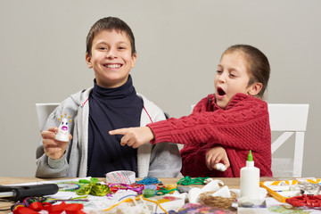 Children make crafts and toys, handmade concept. Artwork workplace with creative accessories.