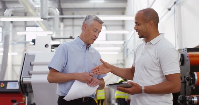 4K Business associates in the printing industry shake hands on a deal