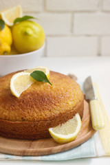 Lemon lavender cake and lemons on a light background. Rustic style.