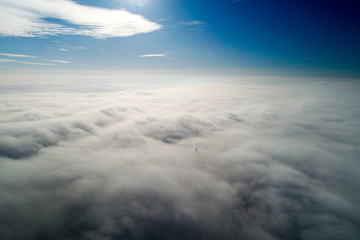 Fog above the ground. Top view of the fog. Low clouds. Morning mist condensation. Shooting with a drone.