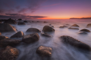 Sunrise over a calm sea at Arribolas beach in Bermeo, Bizkaia