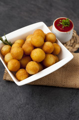 Potato fried croquettes with ketchup.