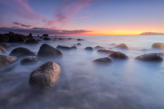 Sunrise over a calm sea at Arribolas beach in Bermeo, Bizkaia