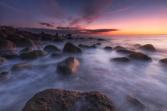 Sunrise over a calm sea at Arribolas beach in Bermeo, Bizkaia