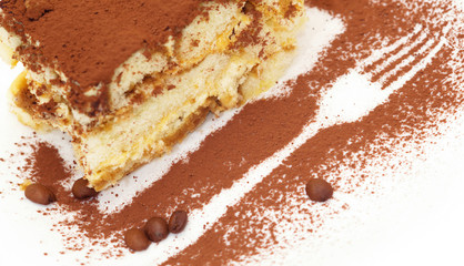 Cake tiramisu with an image of a fork on a plate sprinkled with chocolate