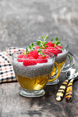 Chia  seed pudding with orange marmalade and fresh raspberries on wooden table