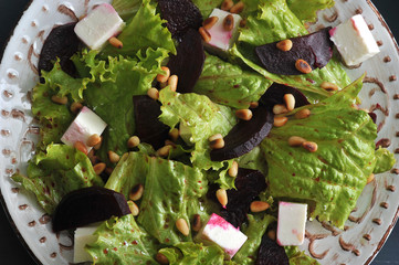 salad with beets, lettuce, feta cheese, roasted pine nuts