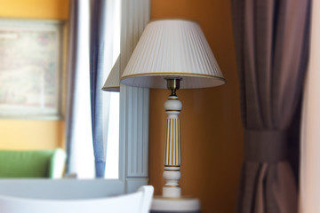 Table lamp with the mirror in a hotel room.