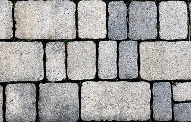 grey tiles give a harmonic pattern at the ground pavement stone