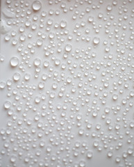 small fine round droplets on a white background