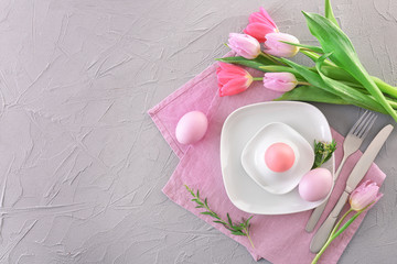 Beautiful festive Easter table setting with tulips and eggs