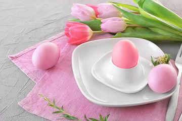 Beautiful festive Easter table setting with tulips and eggs