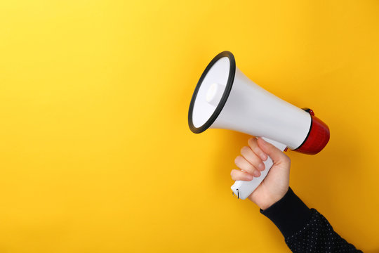 Woman Holding Megaphone On Color Background