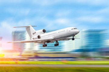 Climbing take off aircraft jet on a city background.