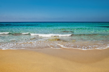Fototapeta na wymiar Sunny day on the beach blue sea orange sand
